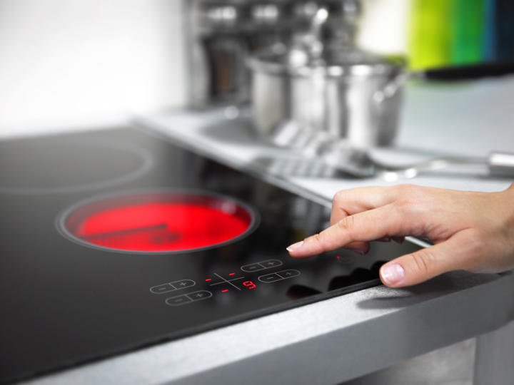 Homeowner adjusts electric stove